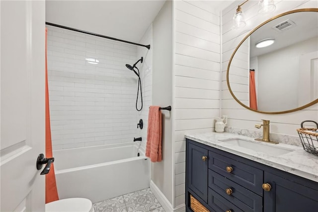 full bathroom featuring visible vents, toilet, vanity, and shower / bath combo with shower curtain