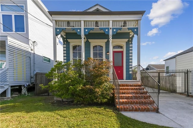 view of front of property with a front lawn and fence