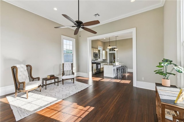 living area with crown molding, a ceiling fan, dark wood-style flooring, and baseboards