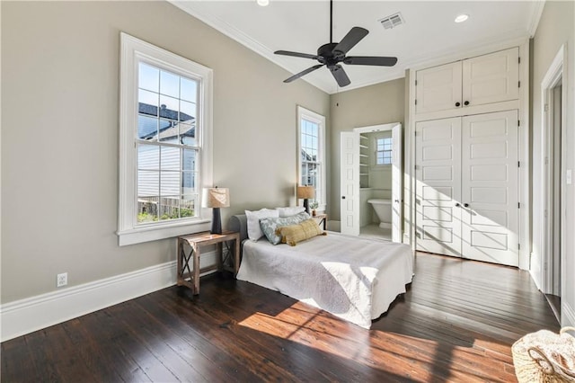 bedroom with crown molding, baseboards, visible vents, and dark wood-type flooring