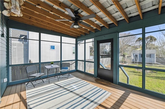 sunroom / solarium featuring ceiling fan and vaulted ceiling