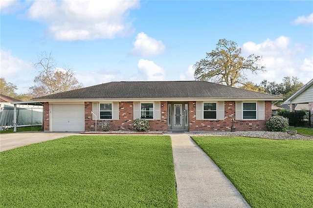 ranch-style home featuring brick siding, a garage, concrete driveway, and a front lawn