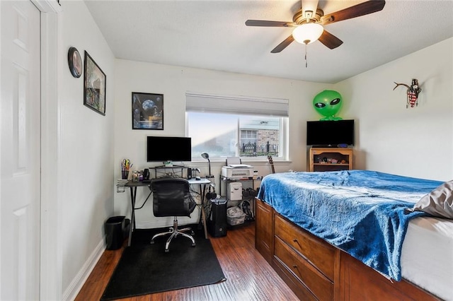 bedroom featuring a ceiling fan, baseboards, and dark wood-style flooring