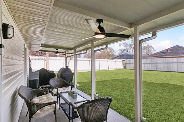 unfurnished sunroom with ceiling fan