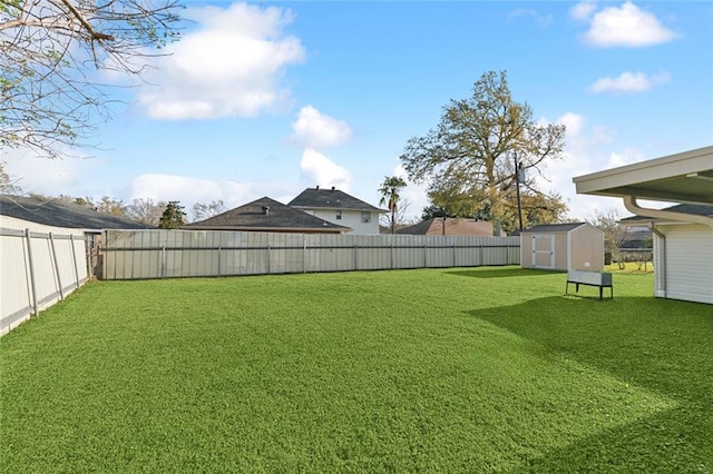 view of yard featuring a fenced backyard, a storage shed, and an outdoor structure