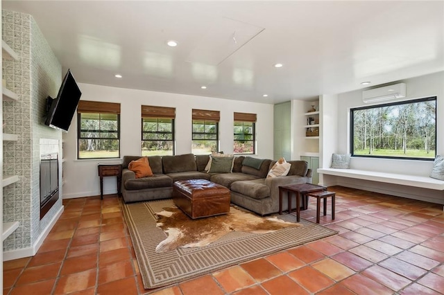 tiled living room featuring a wall unit AC, recessed lighting, and a fireplace
