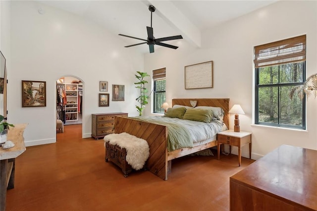 bedroom with lofted ceiling with beams, arched walkways, baseboards, and ceiling fan