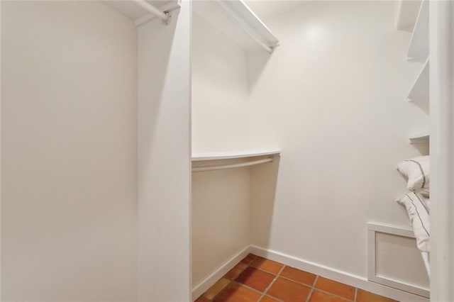 spacious closet with tile patterned floors