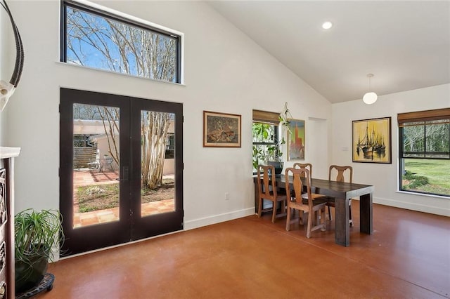 dining space featuring a healthy amount of sunlight, french doors, high vaulted ceiling, and baseboards