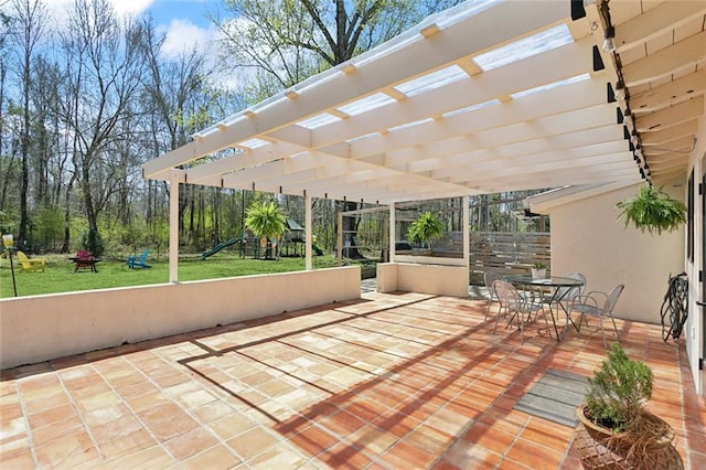 view of patio / terrace with outdoor dining area, a pergola, and a playground