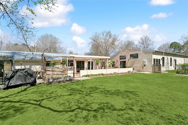 rear view of property featuring stucco siding