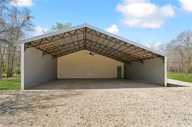 view of outdoor structure featuring gravel driveway and a carport