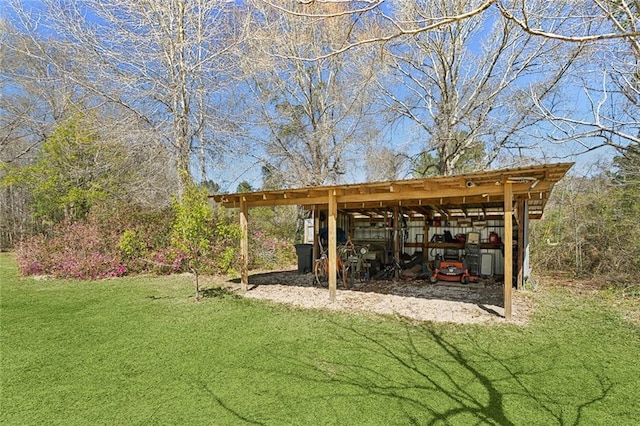 view of yard featuring a detached carport, an outbuilding, and a pole building
