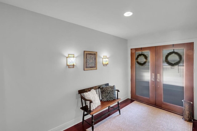 sitting room with recessed lighting, french doors, baseboards, and wood finished floors