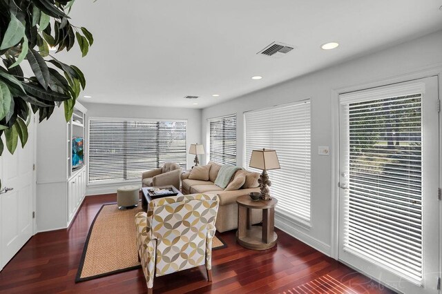 living room featuring recessed lighting, visible vents, and wood finished floors