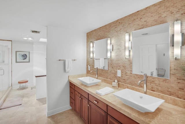 full bathroom with tasteful backsplash, visible vents, double vanity, and a sink