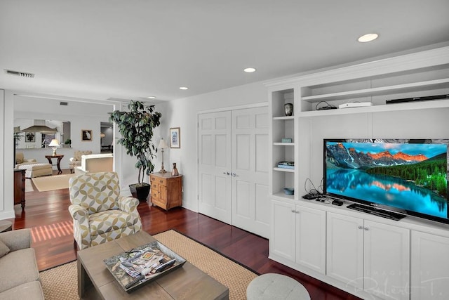 living room featuring dark wood-style floors, visible vents, and recessed lighting