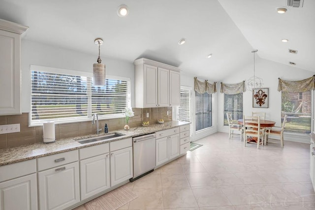 kitchen with a sink, tasteful backsplash, white cabinetry, dishwasher, and vaulted ceiling