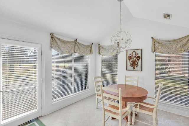 dining space with an inviting chandelier, light tile patterned floors, visible vents, and lofted ceiling