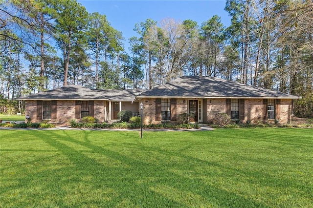 view of front facade featuring a front yard and brick siding