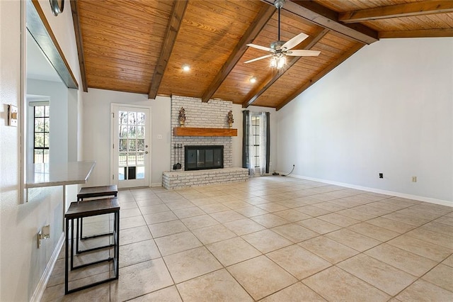 unfurnished living room featuring beamed ceiling, light tile patterned floors, wood ceiling, and ceiling fan