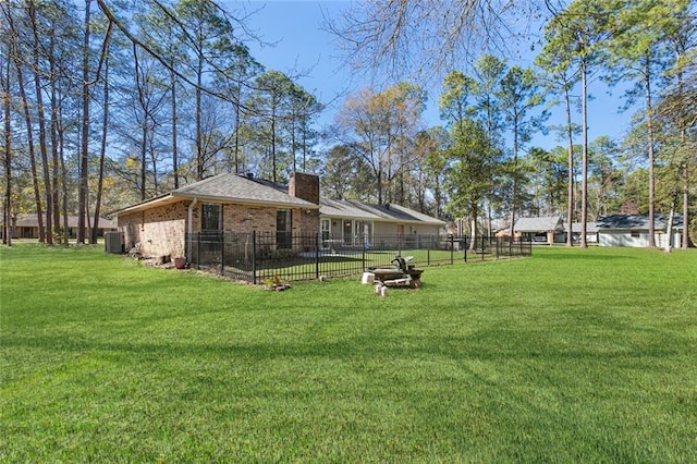 view of yard featuring central AC and fence