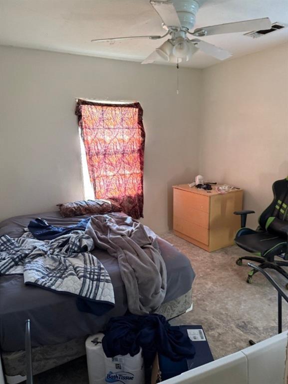 carpeted bedroom featuring visible vents and ceiling fan