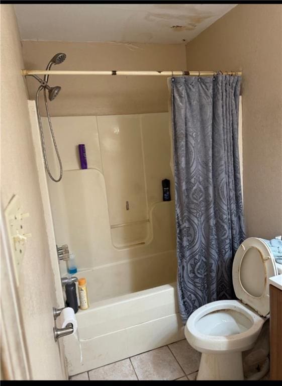 bathroom with tile patterned floors, shower / tub combo with curtain, vanity, and toilet