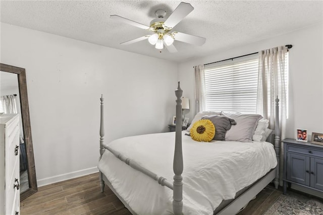 bedroom with a ceiling fan, wood finished floors, baseboards, and a textured ceiling