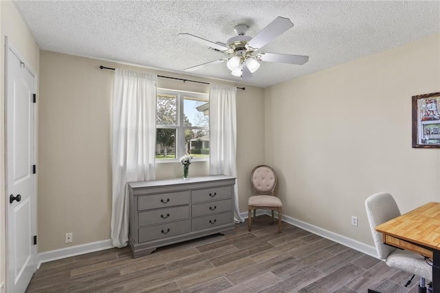 office with a textured ceiling, dark wood-style floors, baseboards, and ceiling fan