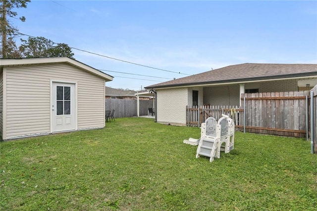 view of yard featuring an outdoor structure and fence private yard