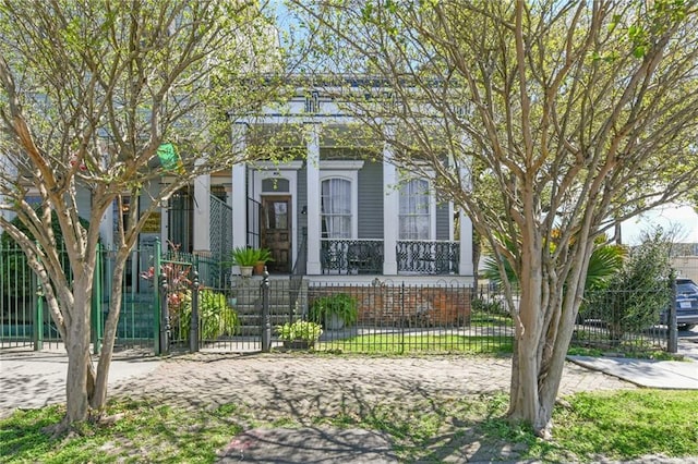 view of front of house with a fenced front yard and a porch