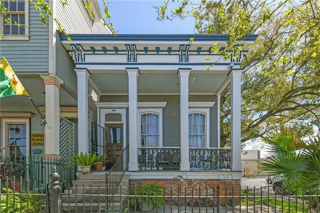 exterior space with a porch and fence