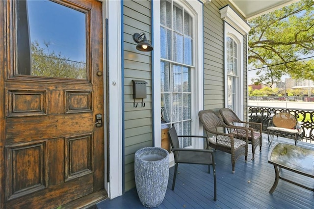 view of exterior entry featuring covered porch