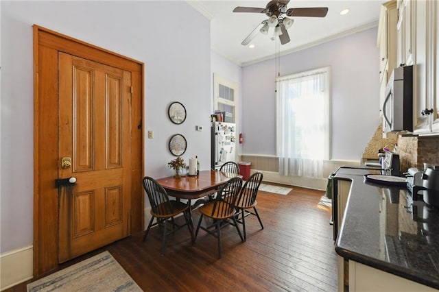 dining space featuring recessed lighting, dark wood finished floors, ornamental molding, and a ceiling fan