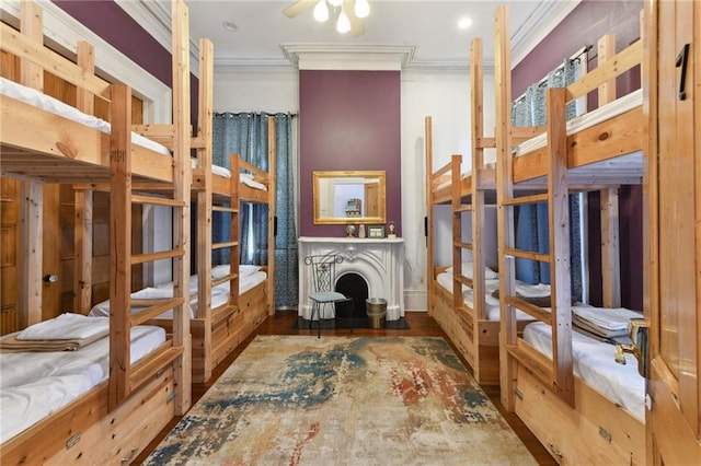 bedroom featuring wood finished floors and crown molding