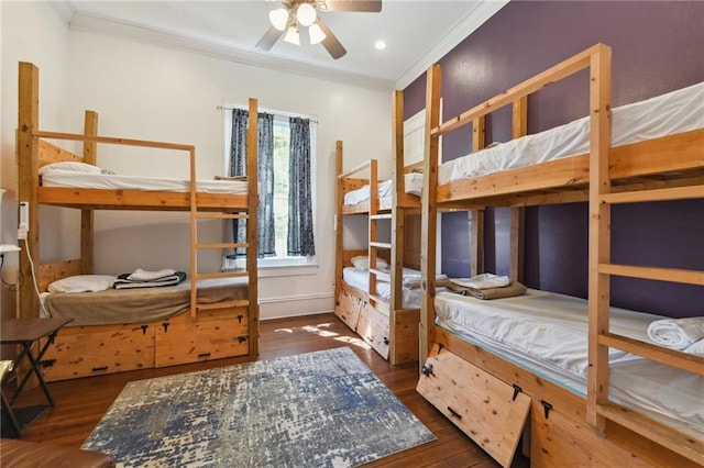 bedroom featuring recessed lighting, wood finished floors, baseboards, and ornamental molding