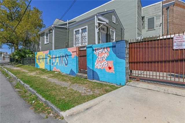 view of side of property featuring fence