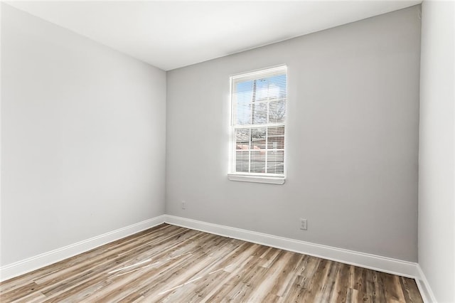 unfurnished room with light wood finished floors and baseboards