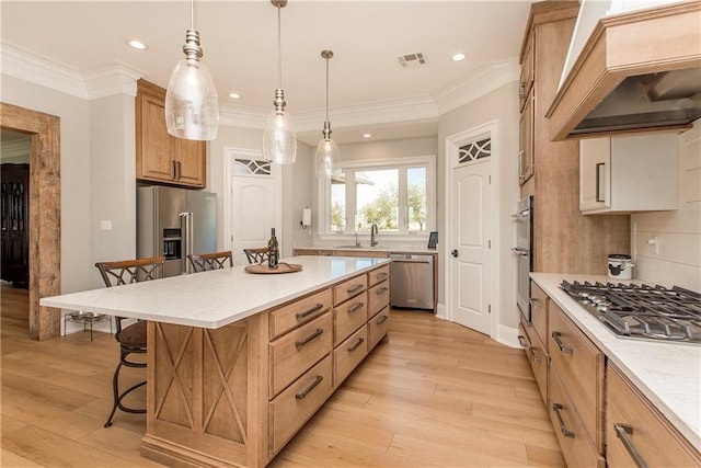 kitchen featuring visible vents, custom range hood, a kitchen breakfast bar, light wood-style floors, and stainless steel appliances