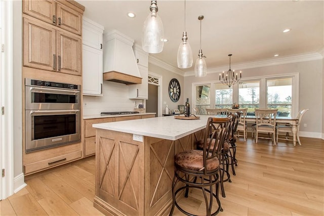 kitchen with tasteful backsplash, custom range hood, ornamental molding, appliances with stainless steel finishes, and light wood-style floors