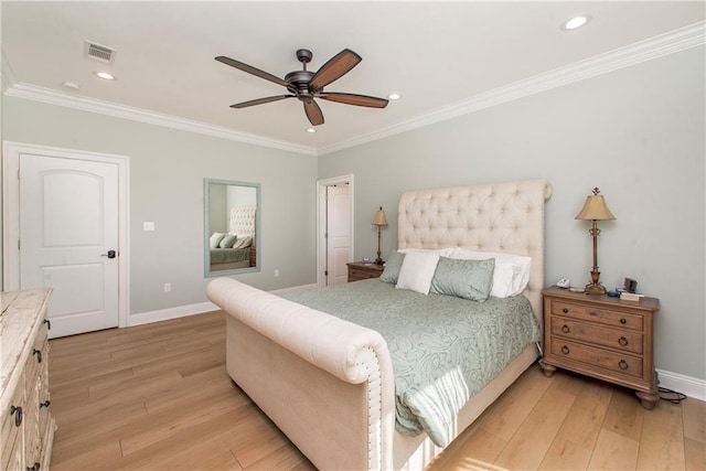 bedroom featuring visible vents, light wood-type flooring, baseboards, and ornamental molding