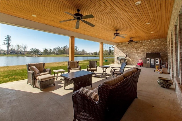 30648 Carter Cemetery Rd, Springfield, LA 70462 - view of patio / terrace featuring a water view, a grill, ceiling fan, and an outdoor hangout area