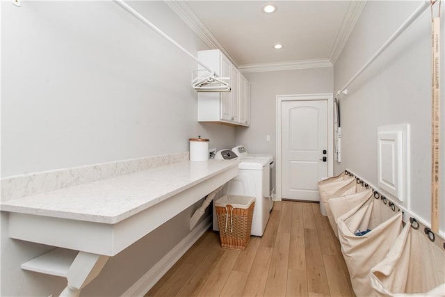 washroom featuring ornamental molding, washer and clothes dryer, recessed lighting, cabinet space, and light wood finished floors