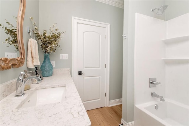 full bath with vanity, shower / bathtub combination, baseboards, and wood finished floors