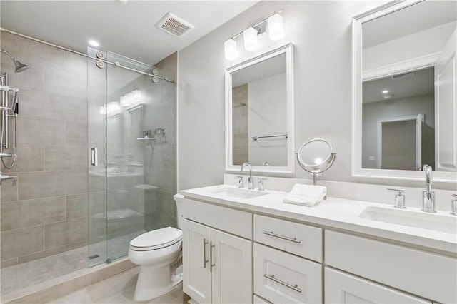 full bath with a sink, a shower stall, toilet, and visible vents