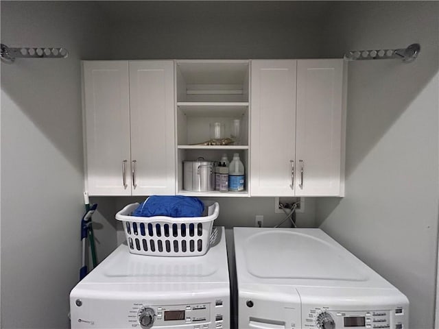 laundry area with cabinet space and independent washer and dryer