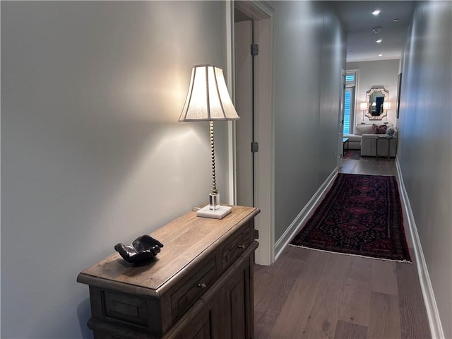 hall featuring recessed lighting, baseboards, and wood finished floors