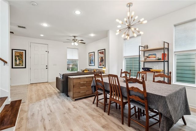 dining space featuring visible vents, ceiling fan with notable chandelier, recessed lighting, light wood-style floors, and baseboards