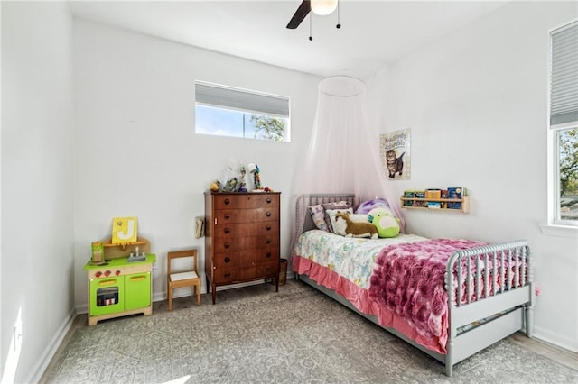 bedroom with multiple windows, baseboards, and ceiling fan